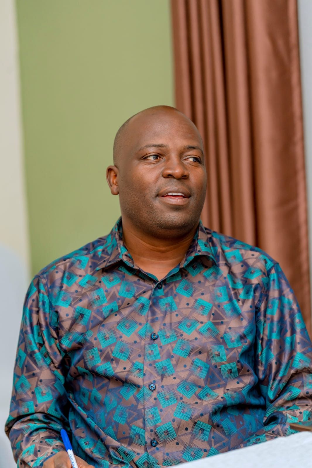 Eric Obwaka taking notes during a business meeting